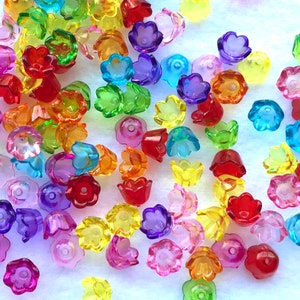 May include: Assortment of colorful plastic flower-shaped beads. The beads are translucent and come in a variety of colors, including red, orange, yellow, green, blue, purple, and pink.