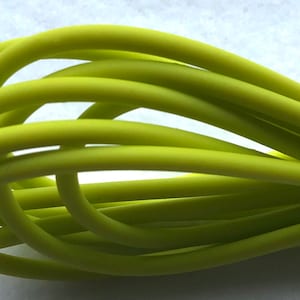 May include: A close-up of a bundle of lime green rubber tubing.