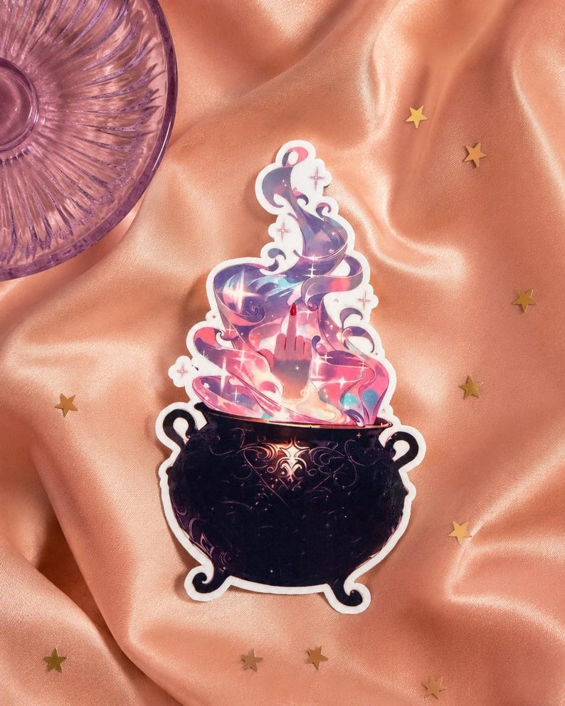 May include: A die-cut sticker featuring a black cauldron with ornate scrollwork patterns. Rising from the cauldron is a swirling cloud of purple, pink, and blue magical smoke, with a hand emerging from the center displaying a middle finger gesture.