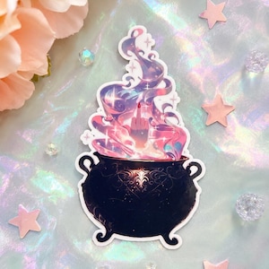 May include: A die-cut sticker featuring a black cauldron with ornate scrollwork patterns. Rising from the cauldron is a swirling, iridescent cloud of pink, purple, and blue smoke containing a hand with a red-painted fingernail making a gesture.