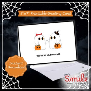 May include: Printable 5x7 inch greeting card featuring two ghosts holding buckets of candy. The text on the card reads "You're my lil boo thang".