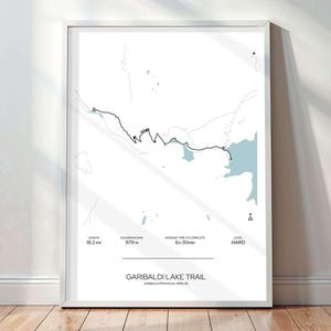May include: A black and white illustration of a trail map for the Garibaldi Lake Trail in Garibaldi Provincial Park, BC. The map shows the trail length of 18.2 km, elevation gain of 979 m, average time to complete of 6 hours and 30 minutes, and difficulty level of hard.