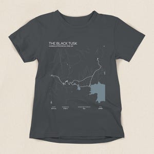 May include: Dark gray t-shirt featuring a map graphic of The Black Tusk in Garibaldi Provincial Park, BC. The shirt includes text indicating the trail's distance, elevation gain, and difficulty level. A stylish tee for outdoor enthusiasts.
