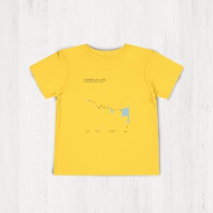May include: A yellow t-shirt with a map of Garibaldi Lake, British Columbia, Canada printed on the front. The map shows the lake and surrounding trails.