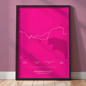 May include: Framed print featuring a hot pink map of Panorama Ridge in Garibaldi Provincial Park, BC. The white trail map shows a 28.3 km route with an elevation gain of 1612 m, and an average time to complete of 10 hours. The difficulty level is marked as hard.