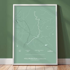 May include: A framed print with a minimalist map design in green and grey. The map shows trail details, elevation, and average completion time. The text at the bottom reads "Hollyburn Peak via Powerline Trail, Cypress Provincial Park, BC."