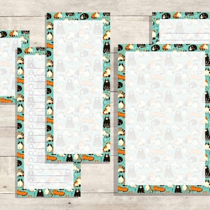 May include: A collection of cat-themed stationery, including notepads and list pads. The stationery features a light blue background with a repeating pattern of various cat illustrations. The borders are teal with cat illustrations. The stationery is arranged on a light wood surface.