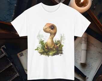 May include: White t-shirt with a cartoon illustration of a small, brown dinosaur with big eyes. The dinosaur is standing in a green, leafy area.
