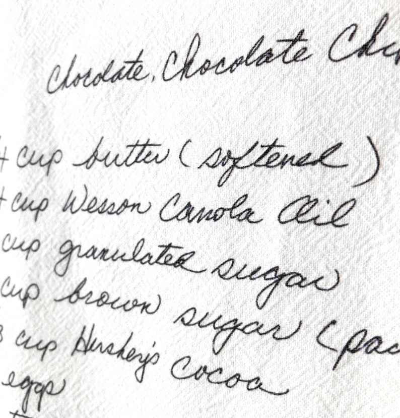 May include: Handwritten recipe for chocolate chip cookies, listing ingredients including butter, canola oil, granulated sugar, brown sugar, and cocoa.