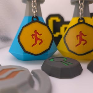 Aangepaste 3D-geprinte RuneScape Mark of Grace-sleutelhanger: iconisch behendigheidsaccessoire, duurzaam en authentiek ontwerp voor OSRS-fans en -verzamelaars