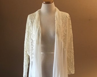 May include: A white lace and chiffon robe with long sleeves. The robe is open in the front and has a flowing silhouette.