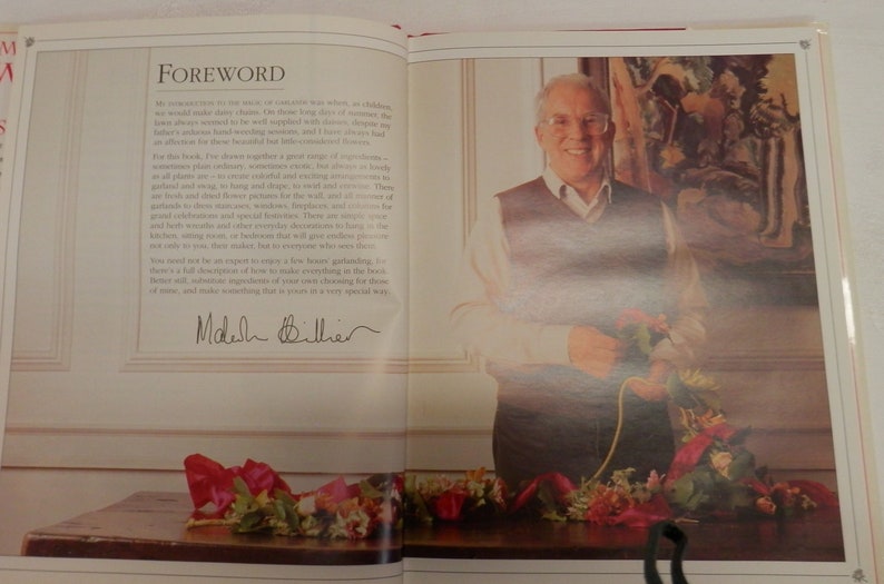 May include: A man in a brown sweater and glasses holds a bouquet of flowers. The text "Foreword" is visible in the background. The man is smiling and looking at the camera. The text "Madelyn  Biller" is signed in black ink.