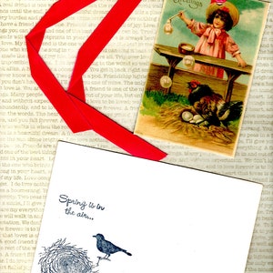 May include: A vintage Easter greeting card with a red ribbon and a girl blowing bubbles. The card features a hen with chicks and the text "Easter Greetings".