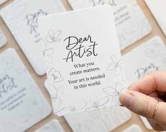 May include: White card with black text and a floral design. The text reads "Dear Artist. What you create matters. Your art is needed in this world."