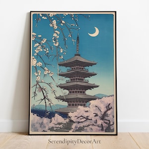May include: A Japanese woodblock print depicting a five-storey pagoda with cherry blossoms in the foreground and a crescent moon in the night sky.