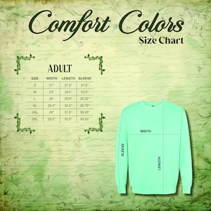 May include: A size chart for Comfort Colors adult sweatshirts. The chart shows measurements for sizes S to 3XL, including width, length, and sleeve length in inches. A light green sweatshirt is shown with measurement lines.