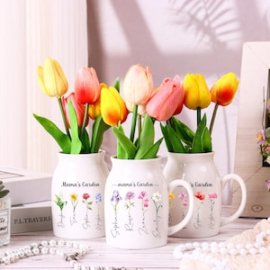 May include: A set of three ceramic mugs with a speckled, matte finish. The mugs are in shades of cream, light gray, and dark gray. Each mug has a simple, minimalist design, perfect for coffee or tea.
