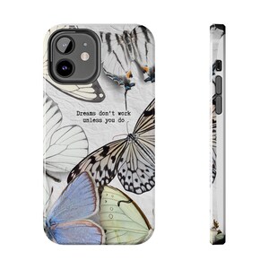 May include: A smartphone case featuring a collage of various butterfly species in shades of white, black, and soft blue. The text "Dreams don't work unless you do" is printed in black in the center. The case has a camera cutout and side buttons.