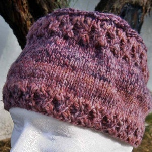 May include: A purple and pink knitted hat with a textured design.