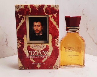 May include: A red and gold box with a portrait of a man on the front. The box says "Tiziano Gentleman's Portrait Aftershave". A clear glass bottle of aftershave with a gold cap and the words "Tiziano Gentleman's Portrait Aftershave" on the label.