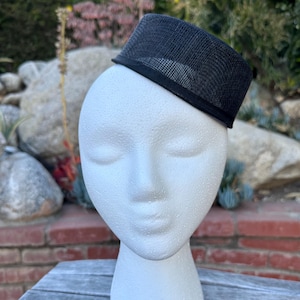 May include: A white ceramic mug with a black handle and the text "But First, Coffee" in a black, bold font. The mug is on a white surface. The mug is 4 inches tall.