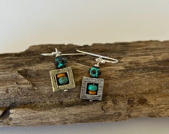 May include: A pair of silver dangle earrings with turquoise and brown beads, set in a square frame.