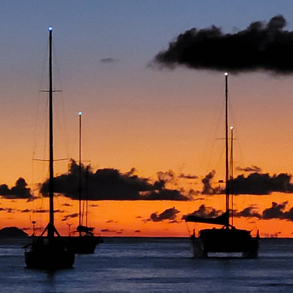 Caribbean sunset, sun, sea, and yachts.