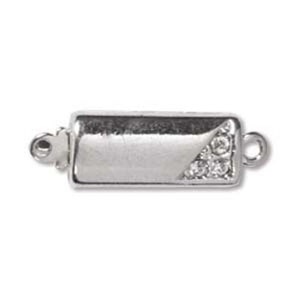 May include: A silver-colored rectangular jewelry clasp with a small triangle of clear crystals on one end. The clasp has a small loop on each end for attaching to jewelry pieces. The clasp is designed to secure necklaces or bracelets.