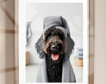 May include: A black dog wearing a gray towel on its head and a gray towel around its body. The dog is looking at the camera and has its tongue sticking out.
