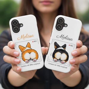 May include: Two white phone cases with corgi butt illustrations. One case features an orange and white corgi, the other a black and white corgi. Each case has the name "Melissa", a "REC" icon, and the text "Camera roll: 98% corgi butt".