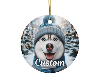 May include: Round ceramic ornament featuring a smiling Husky dog wearing a blue knit hat and scarf. The word "Custom" is printed on the scarf. A gold string is attached for hanging. The background shows a snowy forest.