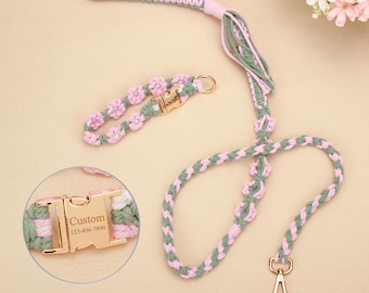 May include: A pink, green, and white braided dog leash and matching collar set. The leash has a handle and a gold-colored clasp. The collar features small pink flower accents and a gold-colored buckle with the word "Custom" and a phone number.