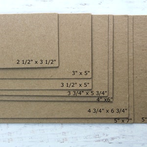 May include: A set of eight brown cardboard squares in various sizes, with measurements in inches labeled on each piece. The squares are arranged in a descending size order, with the largest square at the bottom and the smallest square at the top.