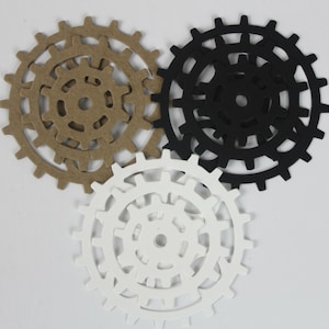 May include: Three sets of interlocking gears, one set is brown, one set is black, and one set is white.