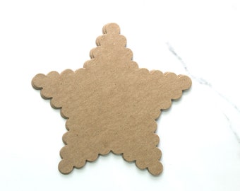 May include: A brown paper star with a scalloped edge. The star is on a white marble background.
