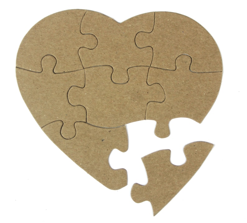 May include: A brown cardboard heart-shaped jigsaw puzzle with one piece missing. The puzzle is made of multiple pieces that fit together to form the shape of a heart.
