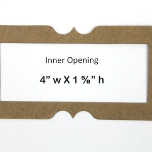 May include: A brown paper frame with a decorative edge. The frame has an inner opening that is 4 inches wide by 1 5/8 inches high. The text "Inner Opening" and the dimensions are printed on the frame.
