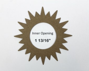 May include: A brown cardboard sunburst shape with a 1 13/16" inner opening.  Inner Opening is written on the shape.