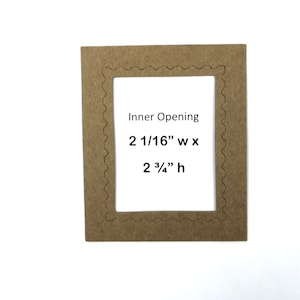 May include: A brown cardboard frame with a scalloped edge and an inner opening measuring 2 1/16" wide by 2 3/4" high. The frame is designed for crafts and scrapbooking.
