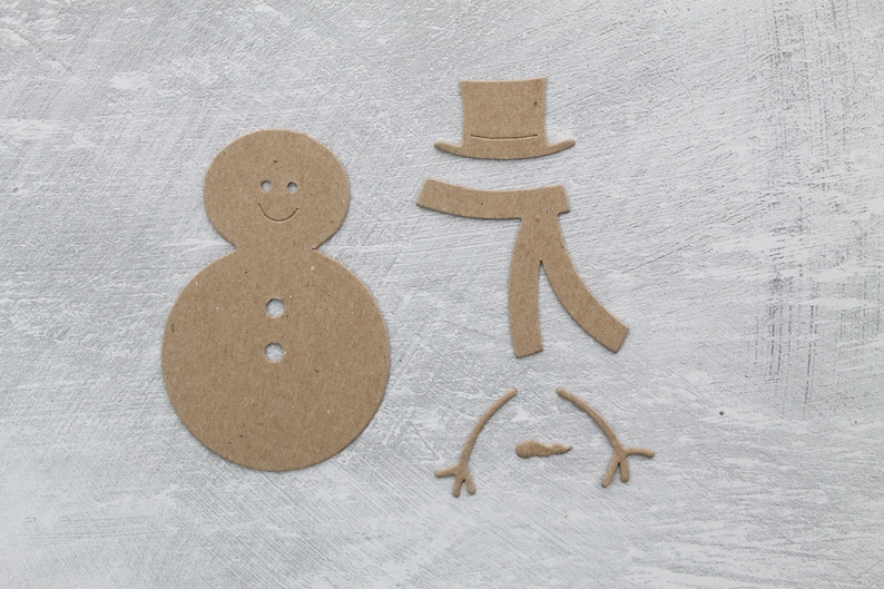 May include: A brown paper snowman craft kit with a round body, a hat, a scarf, and two arms.