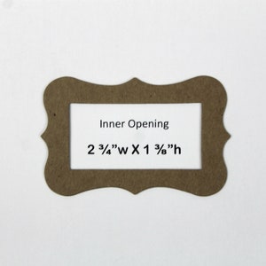 May include: A brown cardboard frame with a scalloped edge and an inner opening measuring 2 3/4" wide by 1 3/8" high. The text "Inner Opening" and the dimensions are printed on a white background inside the frame.