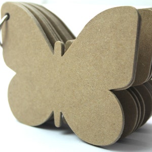 May include: A stack of brown paper butterfly-shaped note cards with a silver ring binder.