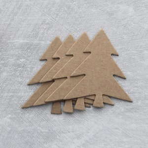 May include: Five brown cardboard Christmas tree shapes stacked on top of each other against a light gray background.