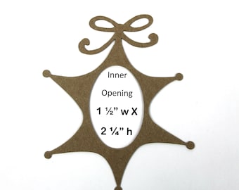 May include: Brown wooden star-shaped ornament with a bow on top and a cut-out oval in the center. The oval has the text "Inner Opening 1 1/2" w x 2 1/4" h" written inside.