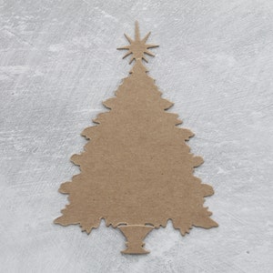 May include: A brown paper Christmas tree cutout with a star on top. The tree is on a gray background.