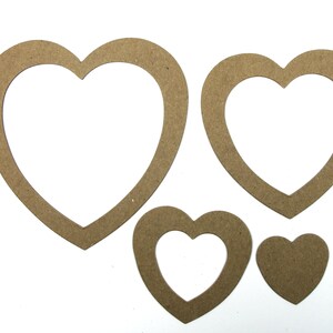 May include: Four brown wooden heart-shaped frames of different sizes. The frames are cut out and have a smooth finish.