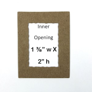 May include: A brown cardboard picture frame with a scalloped edge. The inner opening is 1 3/8" wide by 2" high.