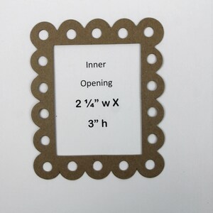 May include: A brown, scalloped-edge frame with a rectangular inner opening. The text on the frame reads "Inner Opening 2 1/4" w X 3" h". The frame is made of a light brown material and is set against a white background.