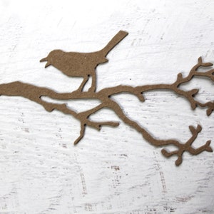 May include: A brown paper silhouette of a bird perched on a branch with leaves.