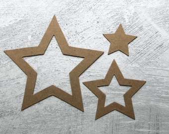 May include: Three brown paper stars of different sizes, arranged on a gray textured background.